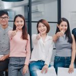 Group of Asia young creative people in smart casual wear smiling